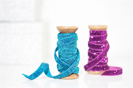 ribbon (material) - Wooden reels of sparkly blue and purple ribbon Stock Photo - Premium Royalty-Free, Code: 649-08329077