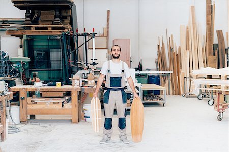 small business portrait full body - Man in workshop with skateboards Stock Photo - Premium Royalty-Free, Code: 649-08329143