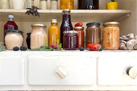 Jars and bottles of home-made food on retro style kitchen cabinet Stock Photo - Premium Royalty-Free, Code: 649-08380907