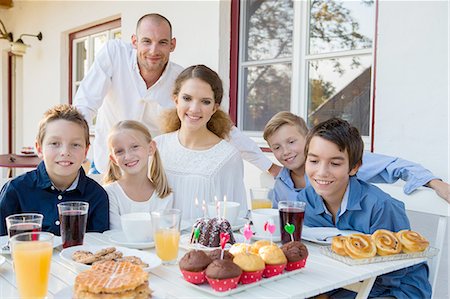 simsearch:649-07648247,k - Portrait of mid adult man and family with birthday cake at patio table Stock Photo - Premium Royalty-Free, Code: 649-08381230