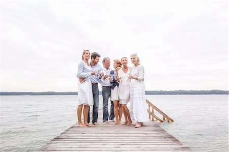 simsearch:649-07760822,k - Group of friends standing on pier, holding wine glasses Stock Photo - Premium Royalty-Free, Code: 649-08381554
