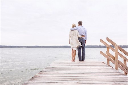 simsearch:614-05557077,k - Mature couple standing on pier, looking at view, rear view Stock Photo - Premium Royalty-Free, Code: 649-08381550