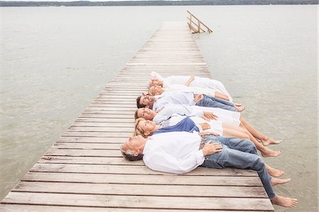 simsearch:649-07760822,k - Group of friends lying in a row, on pier Stock Photo - Premium Royalty-Free, Code: 649-08381564