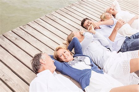 simsearch:649-07760822,k - Group of friends lying in a row, on pier, elevated view Stock Photo - Premium Royalty-Free, Code: 649-08381565