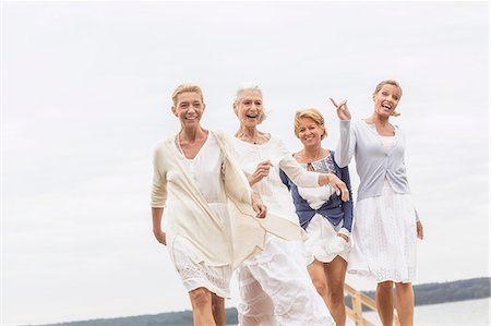 simsearch:649-07760822,k - Group of female friends, walking outdoors, laughing Stock Photo - Premium Royalty-Free, Code: 649-08381569