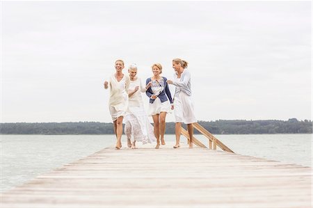 simsearch:649-07760822,k - Group of female friends, walking on pier, laughing Stock Photo - Premium Royalty-Free, Code: 649-08381570