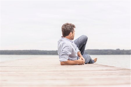 simsearch:614-05557077,k - Mature man relaxing on pier, rear view Stock Photo - Premium Royalty-Free, Code: 649-08381573