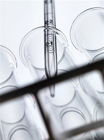 simsearch:649-07279795,k - Low angle view of graduated pipette pipetting liquid into test tube Stock Photo - Premium Royalty-Free, Code: 649-08381845