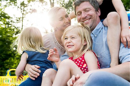 sunny woman outside park - Happy parents and three daughters sharing family picnic in park Stock Photo - Premium Royalty-Free, Code: 649-08422537
