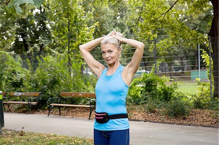 pony tail - Mature woman tying up hair whilst training in park Stock Photo - Premium Royalty-Free, Code: 649-08422576
