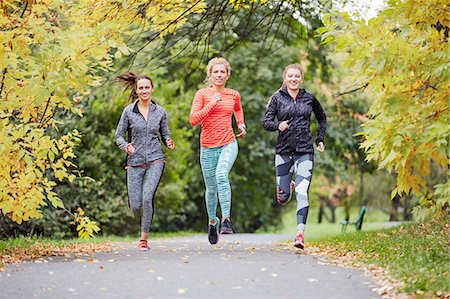 simsearch:628-05817723,k - Three female runners running along park path Stock Photo - Premium Royalty-Free, Code: 649-08422882
