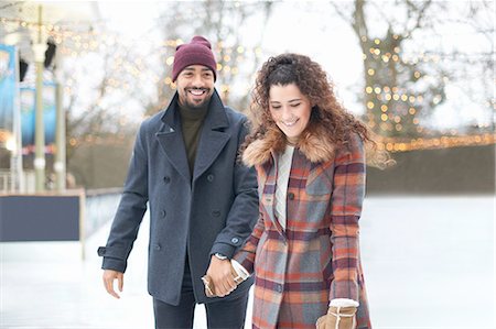 Couple on ice rink holding hands smiling Stock Photo - Premium Royalty-Free, Code: 649-08423377