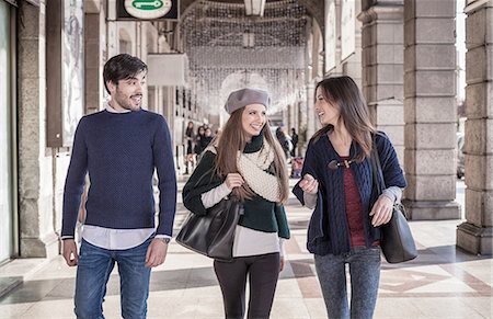 shopping mall - Front view of friends walking side by side in shopping mall smiling Stock Photo - Premium Royalty-Free, Code: 649-08479393