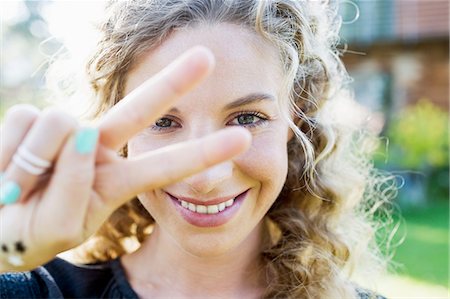 female hand - Young woman making peace sign with hand Stock Photo - Premium Royalty-Free, Code: 649-08479459