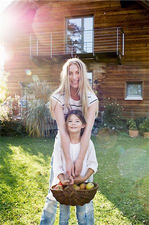 support, nature - Mother and daughter holding basket of apples Stock Photo - Premium Royalty-Free, Code: 649-08479532