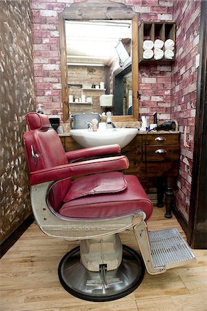 Side view of burgundy leather chair in barbershop Stock Photo - Premium Royalty-Free, Code: 649-08479630