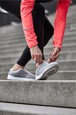 day to day routine - Cropped shot of mature woman training on city stairway, tying trainer laces Stock Photo - Premium Royalty-Free, Code: 649-08544126