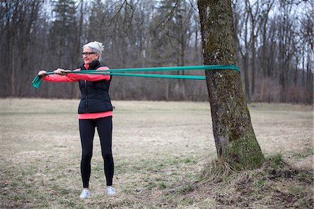 simsearch:693-05552857,k - Mature female training in park, pulling resistance band Stock Photo - Premium Royalty-Free, Code: 649-08544130