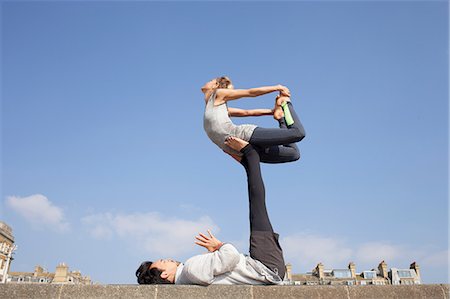 Man and woman practicing acrobatic yoga balance on wall Stock Photo - Premium Royalty-Free, Code: 649-08544224