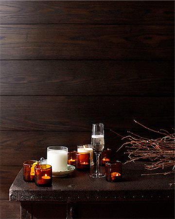 Wooden table with lit candles and glass of champagne Stock Photo - Premium Royalty-Free, Code: 649-08548166
