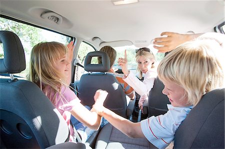 simsearch:649-08232457,k - Children fighting in back seat of vehicle on road trip Stock Photo - Premium Royalty-Free, Code: 649-08548420