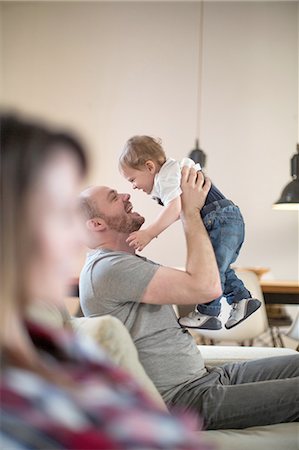 simsearch:649-07437107,k - Father lifting up baby boy face to face smiling Stock Photo - Premium Royalty-Free, Code: 649-08548840
