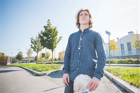 simsearch:649-07710443,k - Portrait of young male urban skateboarder standing on sidewalk Stock Photo - Premium Royalty-Free, Code: 649-08548885