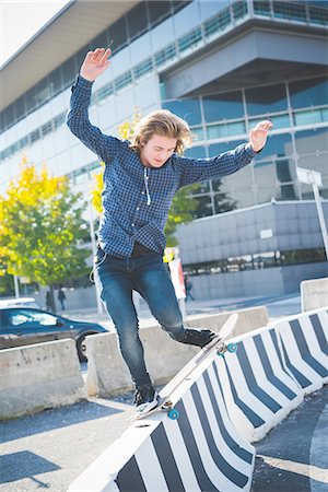 simsearch:649-07710443,k - Young male urban skateboarder balancing on top of concrete barrier Stock Photo - Premium Royalty-Free, Code: 649-08548886