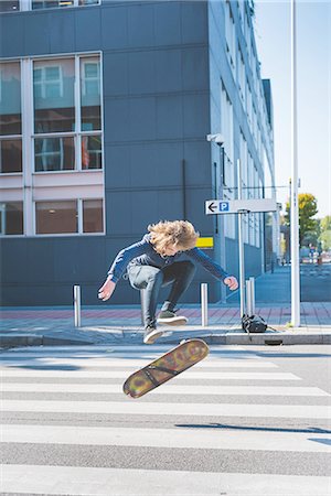 simsearch:649-07710443,k - Young male urban skateboarder doing skateboard jump  on pedestrian crossing Stock Photo - Premium Royalty-Free, Code: 649-08548890