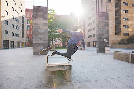 simsearch:649-07710443,k - Young male skateboarder falling head first whilst skateboarding on urban concourse seat Stock Photo - Premium Royalty-Free, Code: 649-08548904
