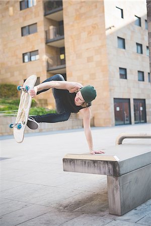 simsearch:649-07710443,k - Young male skateboarder doing balance skateboard trick on urban concourse seat Stock Photo - Premium Royalty-Free, Code: 649-08548905