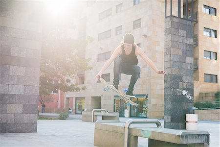 simsearch:649-07710443,k - Young male skateboarder jumping over urban concourse seat Stock Photo - Premium Royalty-Free, Code: 649-08548906
