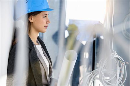 Portrait of young businesswoman in new office behind power cables Stock Photo - Premium Royalty-Free, Code: 649-08543689