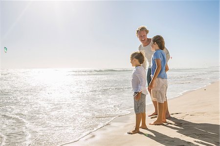 Full length side view of father and sons on beach looking away at ocean Stock Photo - Premium Royalty-Free, Code: 649-08543807