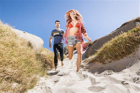 simsearch:649-08239088,k - Couple outdoors, holding hands, running down towards beach Stock Photo - Premium Royalty-Free, Code: 649-08543903