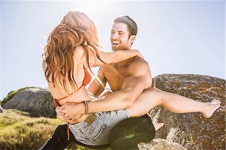 flirting - Couple outdoors, woman sitting on man's lap, face to face, laughing Stock Photo - Premium Royalty-Free, Code: 649-08543928