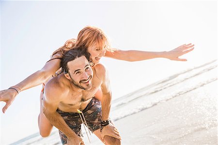 simsearch:649-07585546,k - Mid adult man giving girlfriend piggyback on beach, Cape Town, South Africa Stock Photo - Premium Royalty-Free, Code: 649-08543998