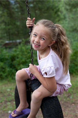 Girl on a tyre swing Stock Photo - Premium Royalty-Free, Code: 649-08564244