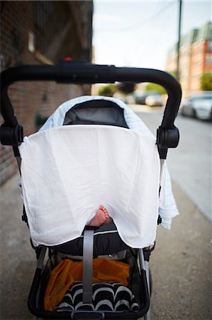 Baby boy's foot sticking out from under muslin in push chair Stock Photo - Premium Royalty-Free, Code: 649-08564285