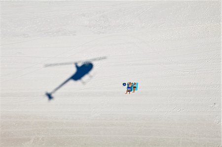 strano - Two tourists on beach with shadow of helicopter, Destin, Florida, USA Fotografie stock - Premium Royalty-Free, Codice: 649-08565475