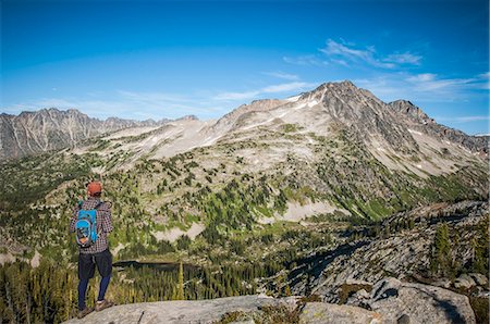 Hiker looking at view of Kokanee Glacier Provincial Park and the Selkirk Mountain Ranges, Nelson, British Columbia, Canada Stock Photo - Premium Royalty-Free, Code: 649-08565694