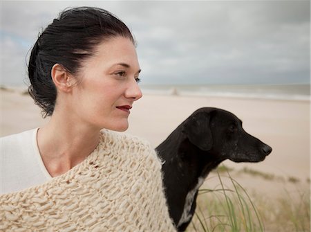 simsearch:632-05845617,k - Woman with dog looking out to the ocean Stock Photo - Premium Royalty-Free, Code: 649-08560610
