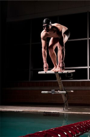 diving - Swimmer poised to dive into pool Stock Photo - Premium Royalty-Free, Code: 649-08560911