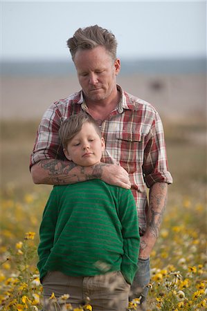simsearch:649-09078617,k - Man hugging son in field of flowers Stock Photo - Premium Royalty-Free, Code: 649-08561840