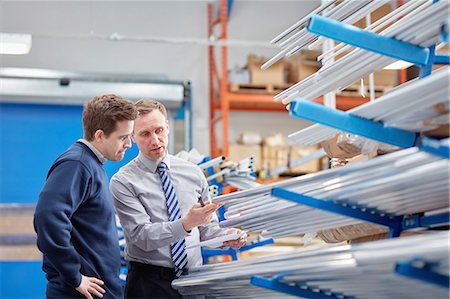 supervising - Manager and factory worker checking shelves of metal rods in roller blind factory Stock Photo - Premium Royalty-Free, Code: 649-08576626