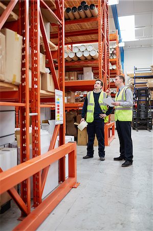 simsearch:649-07239373,k - Manager and male factory worker checking paperwork in factory warehouse Stock Photo - Premium Royalty-Free, Code: 649-08576639