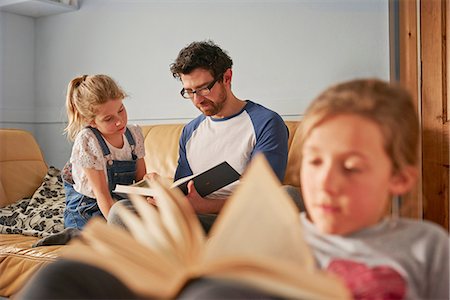 simsearch:614-08270379,k - Girl, sister and father reading books in living room Stock Photo - Premium Royalty-Free, Code: 649-08577241
