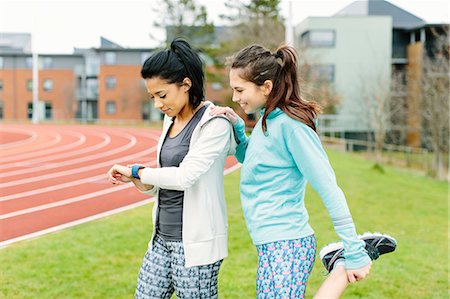 Two young women outdoors, exercising, stretching Stock Photo - Premium Royalty-Free, Code: 649-08577260