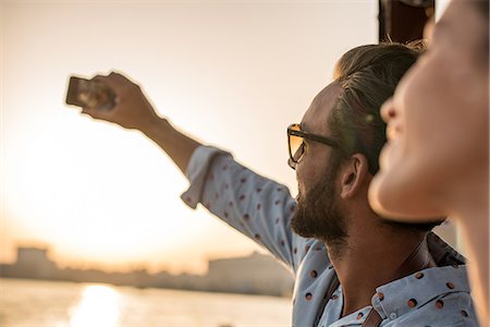 Close up of romantic couple taking smartphone selfie at Dubai marina, United Arab Emirates Stock Photo - Premium Royalty-Free, Code: 649-08577648