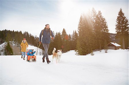 sleds - Parents pulling sons on toboggan in snow covered landscape, Elmau, Bavaria, Germany Stock Photo - Premium Royalty-Free, Code: 649-08577727